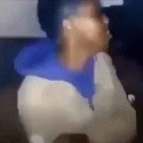 A Blurry Picture Of A Person Talking On A Phone . GIF