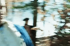 A Blurry Picture Of A Person Walking In A Puddle Of Water . GIF