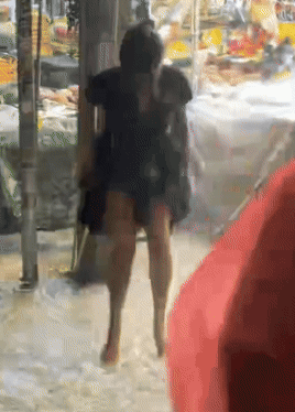 A Blurry Picture Of A Person Walking In The Rain GIF