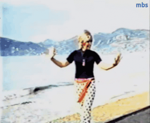 A Blurry Picture Of A Person Walking On A Beach With Mbs Written In The Corner GIF