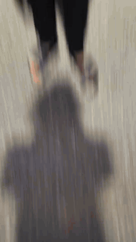 a blurry picture of a person walking on a carpet