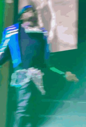 A Blurry Picture Of A Person Walking On A Green Floor GIF
