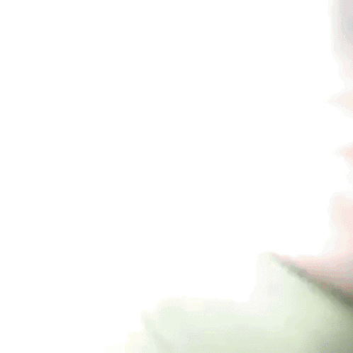 A Blurry Picture Of A Person Wearing A Green Shirt And A Blue Hat . GIF