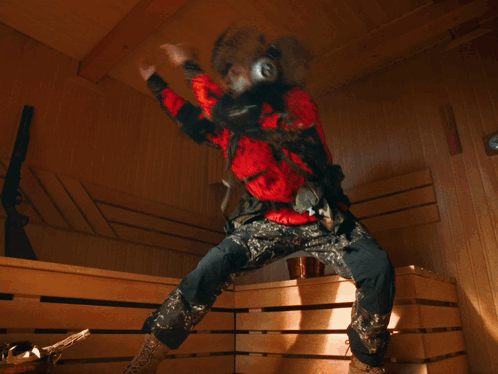 A Blurry Picture Of A Person Wearing Headphones And A Red Jacket With The Letter A On It GIF