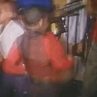 A Blurry Picture Of A Person Wearing Headphones And A Red Shirt In A Dark Room . GIF