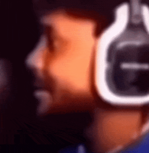 A Blurry Picture Of A Person Wearing Headphones With The Letter G On The Bottom GIF
