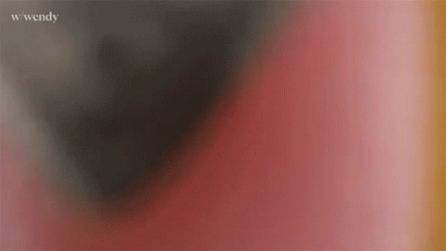 A Blurry Picture Of A Red And Black Background With The Word Wendy Written On The Bottom . GIF