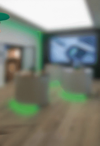 A Blurry Picture Of A Room With Green Lights GIF