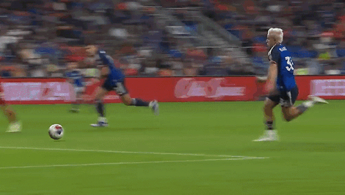 A Blurry Picture Of A Soccer Field With A Sign That Says ' Allianz ' GIF
