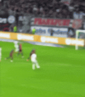 A Blurry Picture Of A Soccer Field With A Sign That Says ' Allianz ' GIF