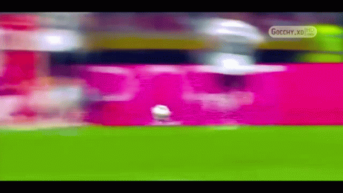 a blurry picture of a soccer field with the words gocchy.xd on the bottom right