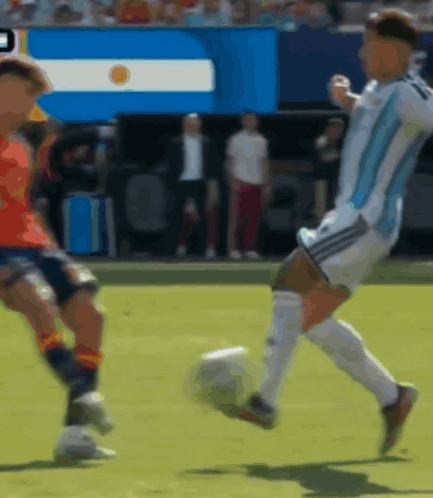 a blurry picture of a soccer game with a flag in the background that says ' argentina '