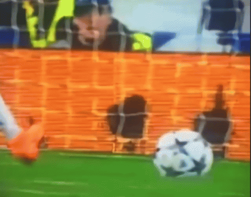 a blurry picture of a soccer game with a goalie and a soccer ball