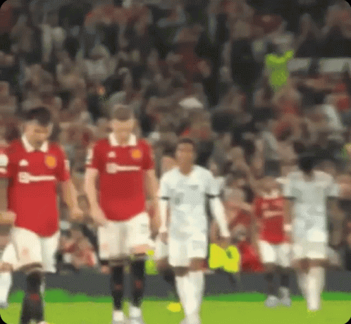 A Blurry Picture Of A Soccer Game With Players In Red And White GIF