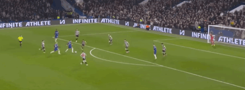 A Blurry Picture Of A Soccer Game With Players On The Field And A Crowd Watching GIF