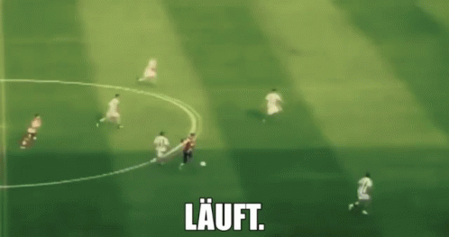 a blurry picture of a soccer game with the word lauft in white