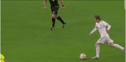 A Blurry Picture Of A Soccer Player Kicking A Soccer Ball GIF