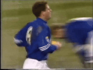 A Blurry Picture Of A Soccer Player Wearing A Blue Jersey With The Number 8 On It GIF