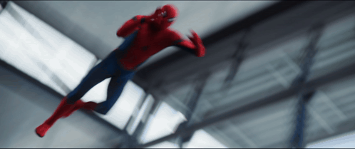 A Blurry Picture Of A Spiderman Flying Through A Building GIF