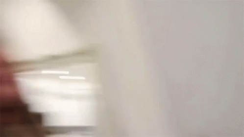 A Blurry Picture Of A Woman Drinking From A Glass . GIF