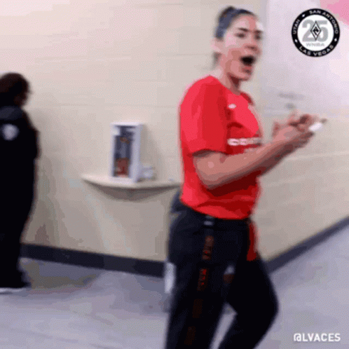 A Blurry Picture Of A Woman In A Red Shirt And Black Pants With The Hashtag @Lvaches GIF
