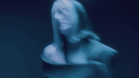 A Blurry Picture Of A Woman 'S Face And Torso GIF