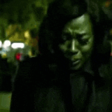 A Blurry Picture Of A Woman 'S Face In A Dark Room GIF