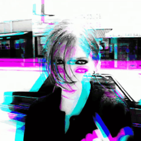 A Blurry Picture Of A Woman 'S Face With A Purple Background GIF