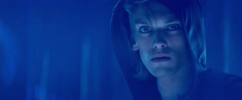 A Blurry Picture Of A Woman 'S Face With Blue Lights In The Background GIF