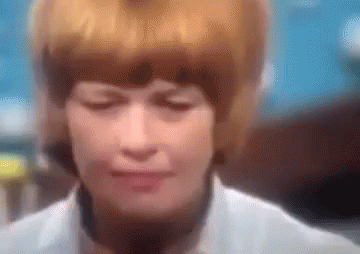 A Blurry Picture Of A Woman 'S Face With Her Eyes Closed . GIF