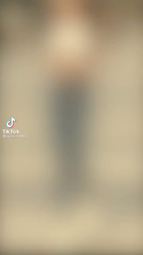 A Blurry Picture Of A Woman Walking Down A Street GIF