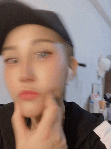 A Blurry Picture Of A Woman Wearing A Black Hat GIF