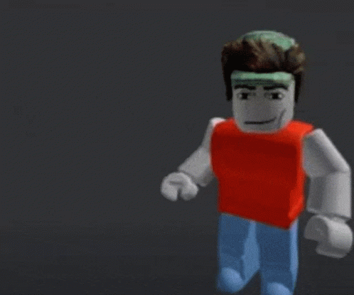 A Blurry Picture Of A Yellow And Red Lego Figure Holding A Red Ball With The Word Baller Written On It GIF
