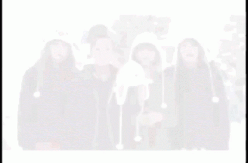 A Blurry Picture Of Four Women Wearing Hats Including One That Looks Like A Penguin GIF