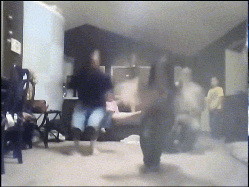 A Blurry Picture Of People Dancing In A Room GIF