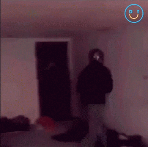 a blurry picture of people in a dark room with a smiley face in the corner