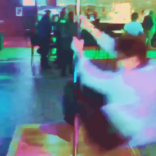 A Blurry Picture Of People Sitting At Tables In A Bar GIF