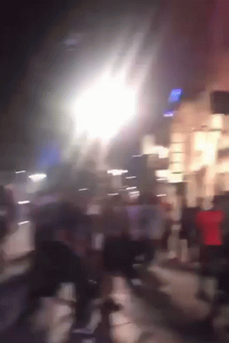 A Blurry Picture Of People Walking Down A Street With A Sign That Says ' Subway ' On It GIF
