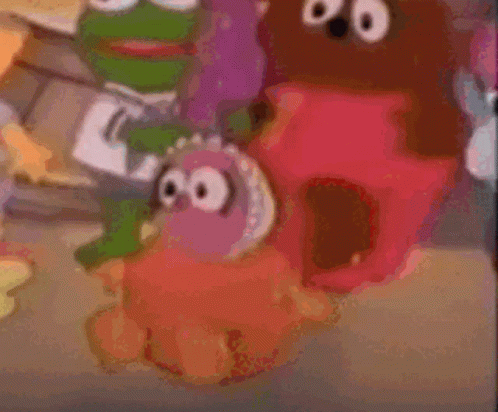 a blurry picture of sesame street characters including a frog