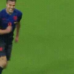 a blurry picture of soccer players on a field with one wearing yellow shorts