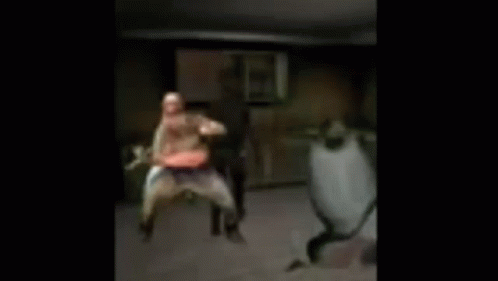 A Blurry Picture Of Three People Dancing In A Room . GIF