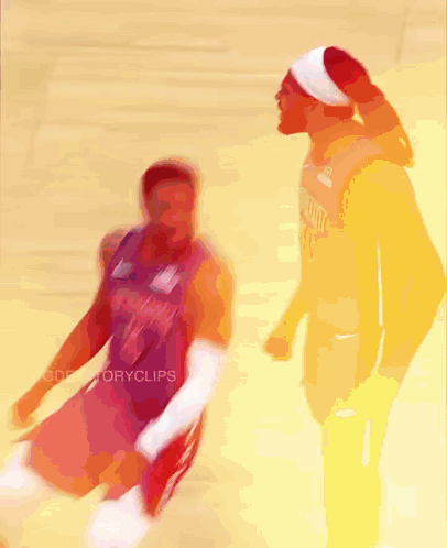 a blurry picture of two basketball players with one wearing a jersey that says ' miami ' on it