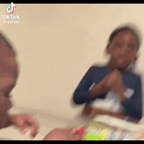 A Blurry Picture Of Two Children Playing With A Baby In A Diaper . GIF