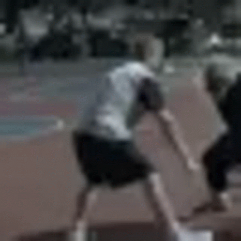 a blurry picture of two men playing soccer on a track .