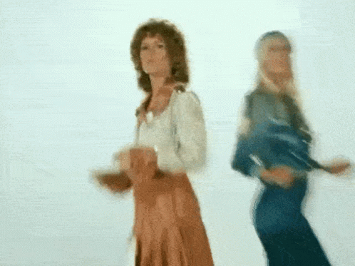 A Blurry Picture Of Two Women Dancing Together GIF