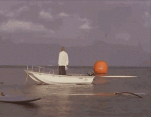 A Boat Is Being Launched Into The Ocean With Smoke Coming From It GIF