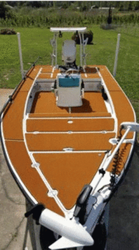 A Boat With A Motor Attached To It Is Parked On A Sidewalk GIF