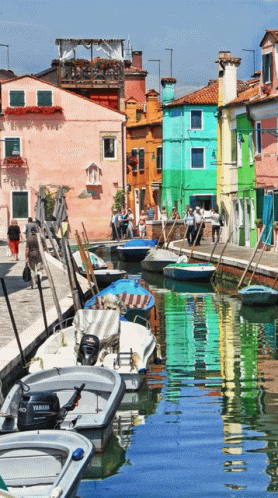 A Boat With A Yamaha Outboard Motor Is Docked In A Harbor GIF
