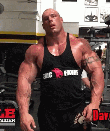 A Bodybuilder Wearing A Black Tank Top That Says Eric Favre On It GIF