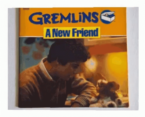 A Book Called Gremlins A New Friend Has A Picture Of A Man GIF